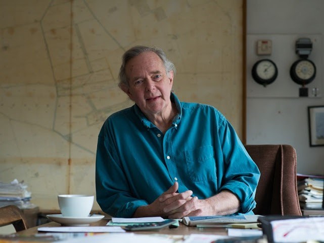 Peter Melchett sat at a desk with hands together