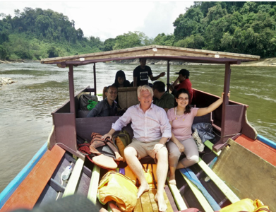 Forestry team members, Sonia Nayar and Andy Grundy, taking a boat ride with the auditor team in Borneo