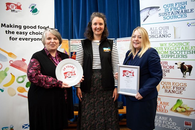 Stirling Council's Bryony Monaghan and Janice Fanning receive the Food for Life Served Here Silver award from Soil Association Scotland's Sarah Duley (centre)